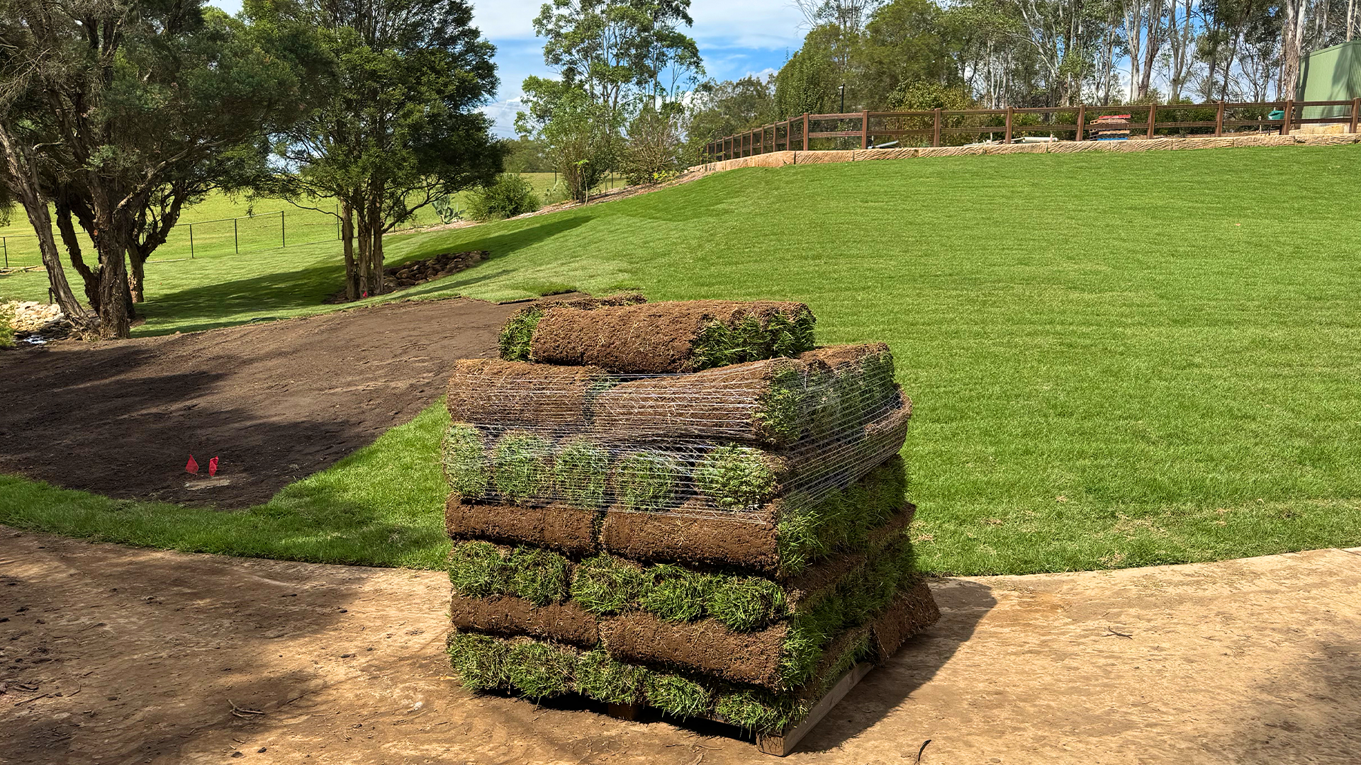 A pile of fresh cut turf placed in a green field