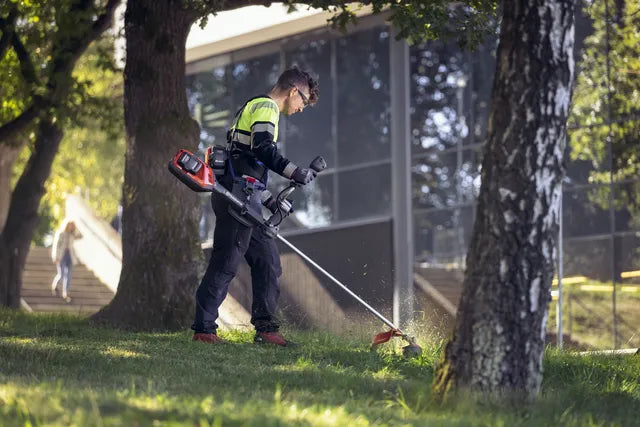 Landscaper using Husqvarna 325iRJ Trimmer
